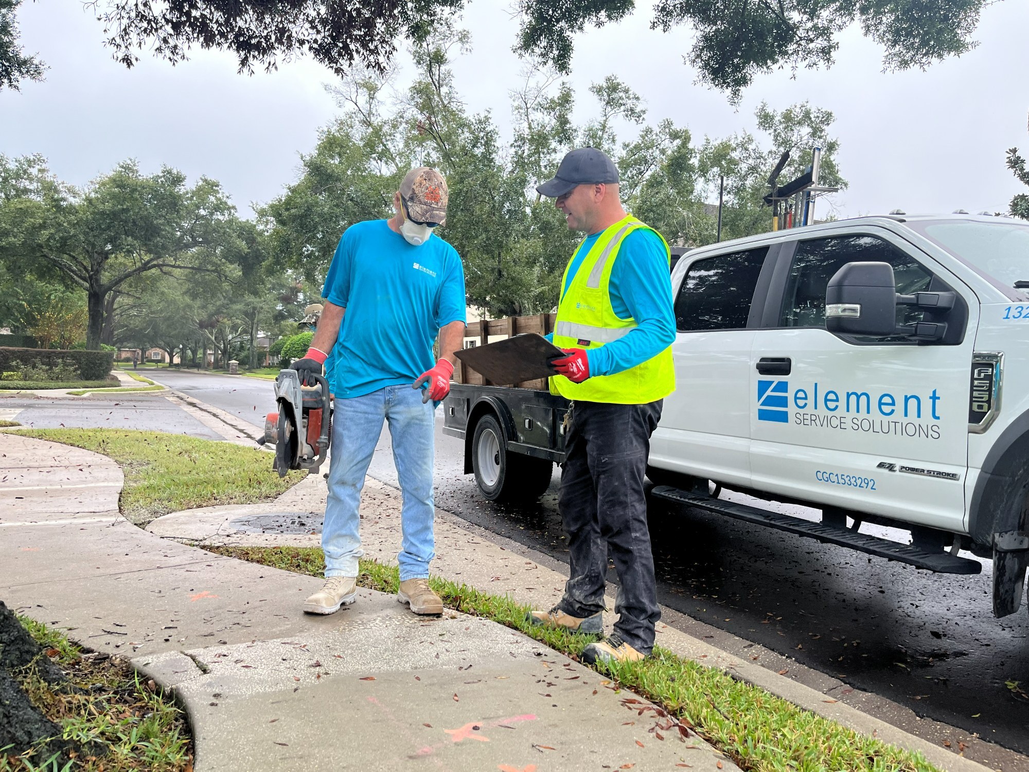 Element Service Solutions crew coordinating a concrete repair at a residential driveway.