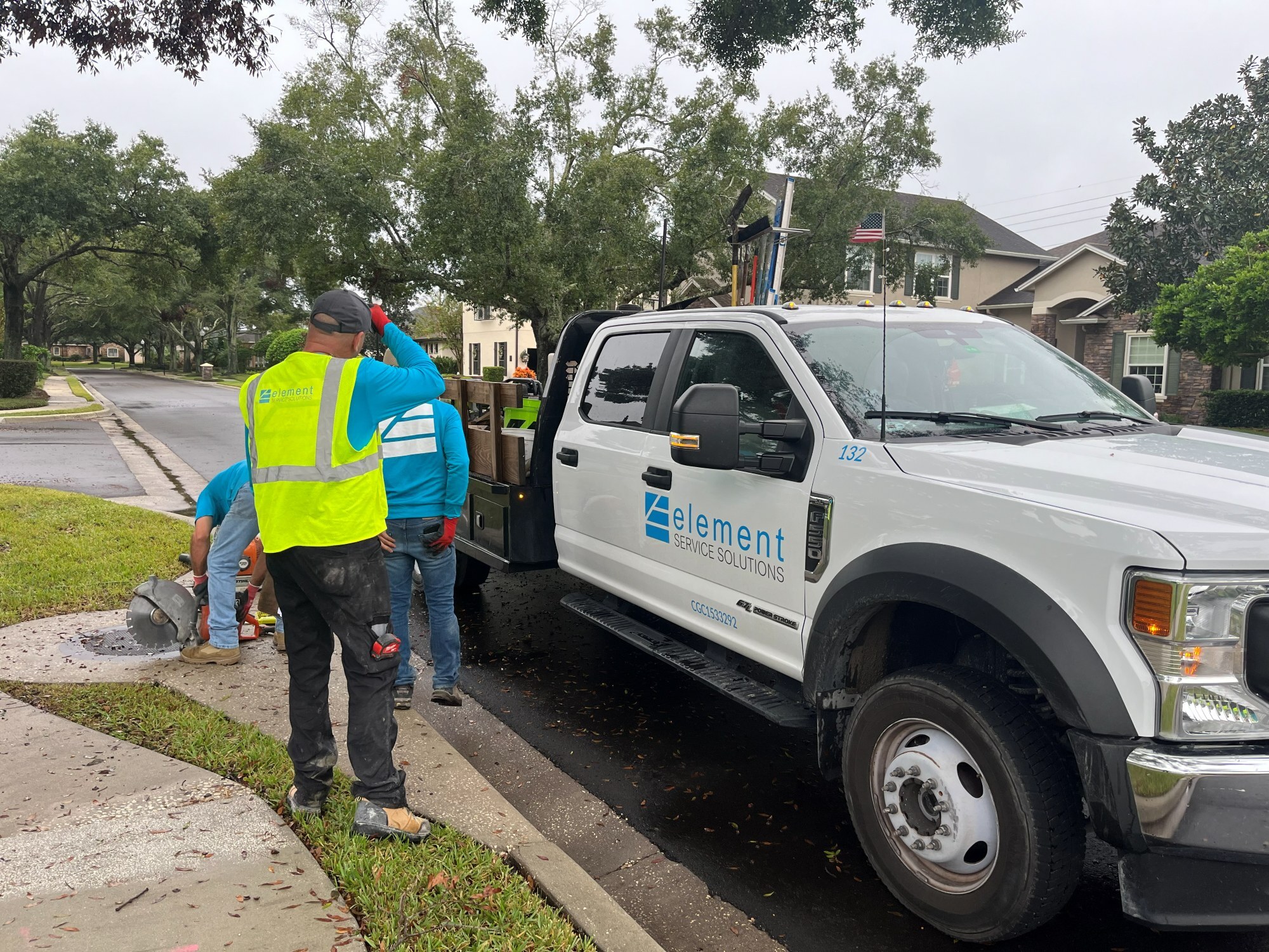 Element Service Solutions crew performing concrete repair work at a community curb line.